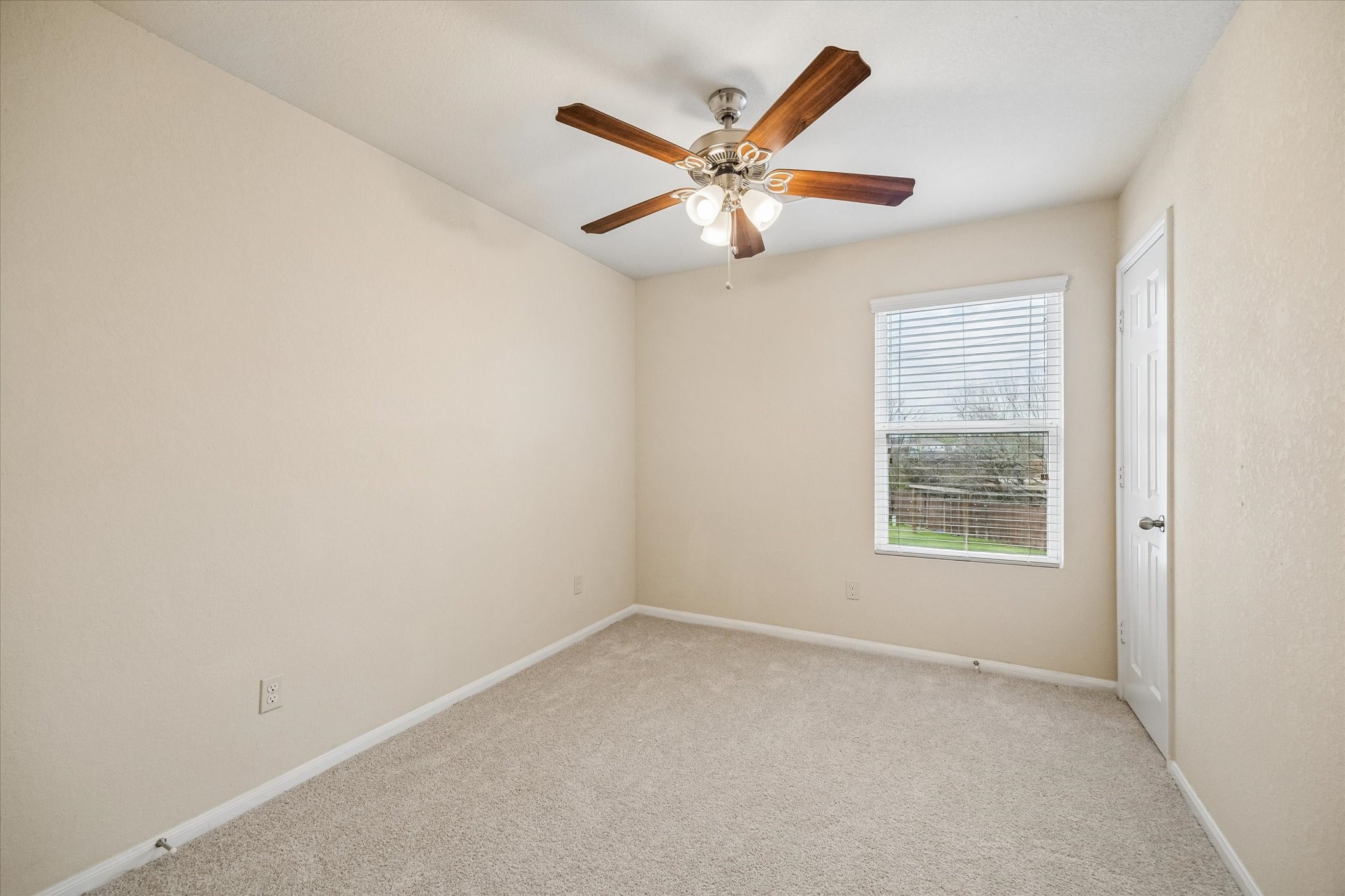 15642 South Fall Fern Circle Houston, TX 77044 - Photo 21 of 25 an empty room with a window and a fan