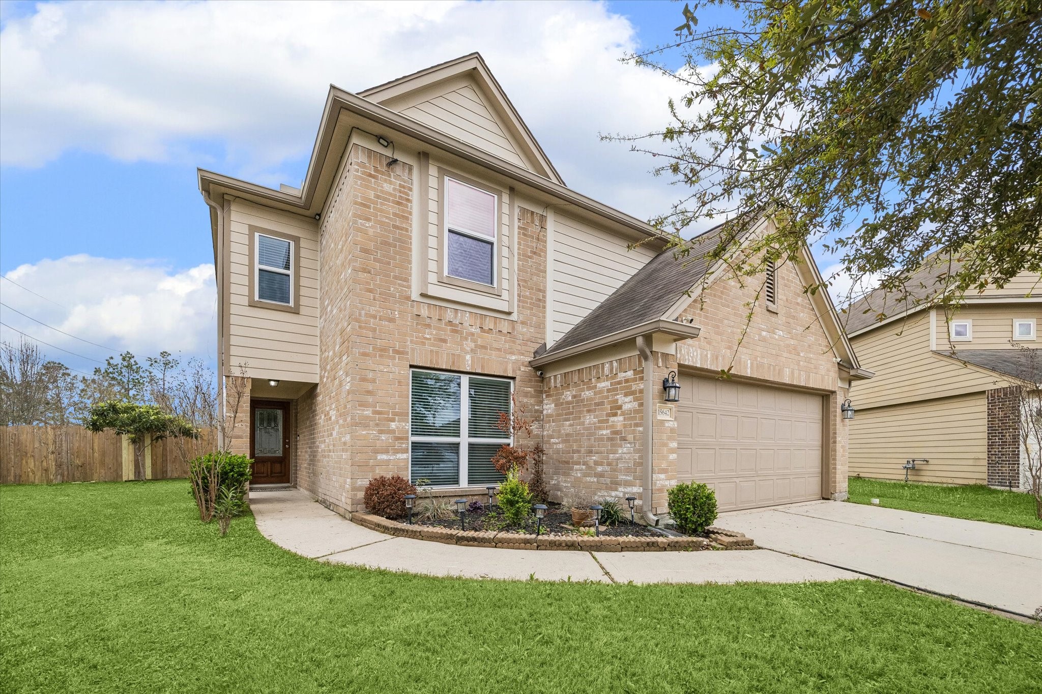 15642 South Fall Fern Circle Houston, TX 77044 - Photo 7 of 25 a front view of a house with a yard and garage