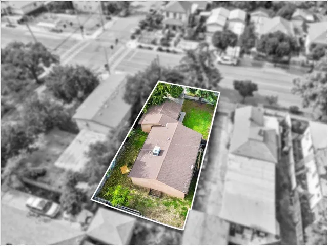 an aerial view of a house with a yard and potted plants