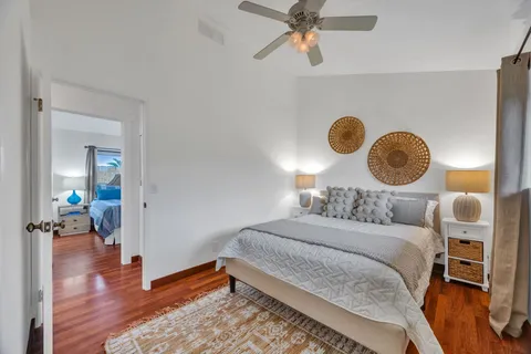 a bedroom with a bed and a chandelier