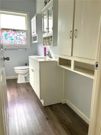a bathroom with a toilet sink and a window