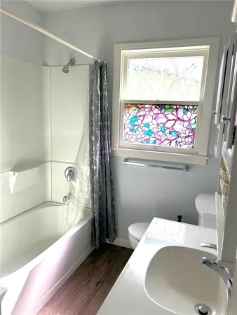 a bathroom with a sink and bathtub with toilet