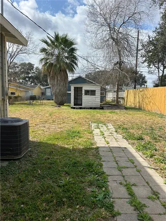 a view of a house with a yard and potted plants