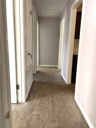 a view of a hallway to rooms