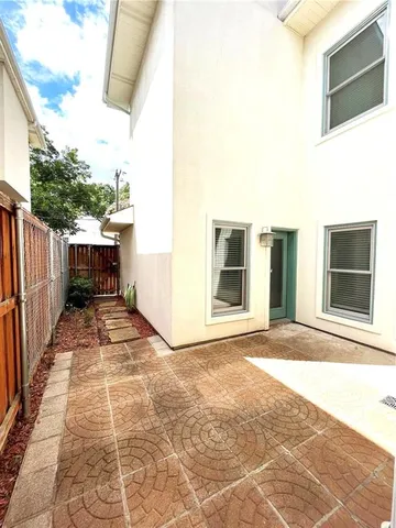 a view of house with backyard and parking