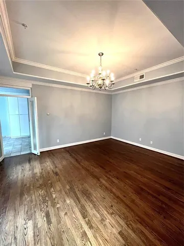 a view of a room with wooden floor