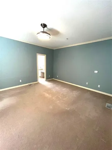 an empty room with a ceiling fan and window