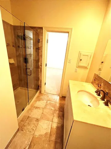 a bathroom with a tub and shower