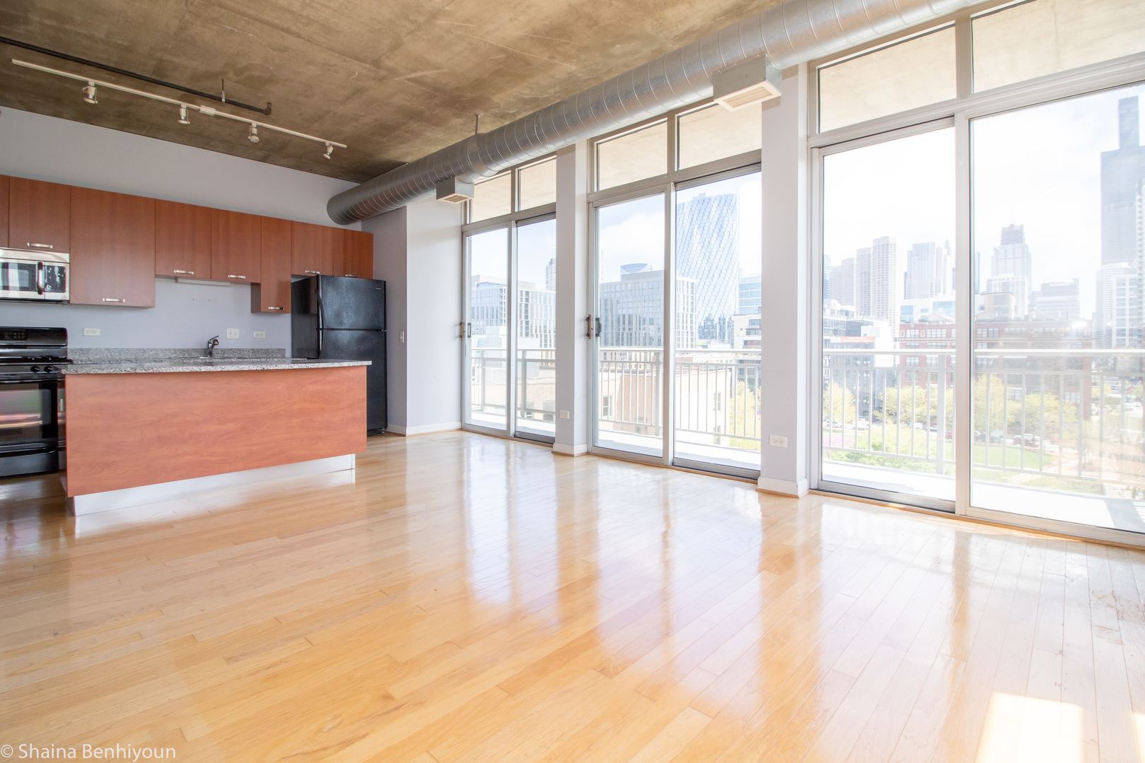 111 South Morgan Street, Unit 715 Chicago, IL 60607 - Photo 11 of 17 a view of an empty room with wooden floor and a window
