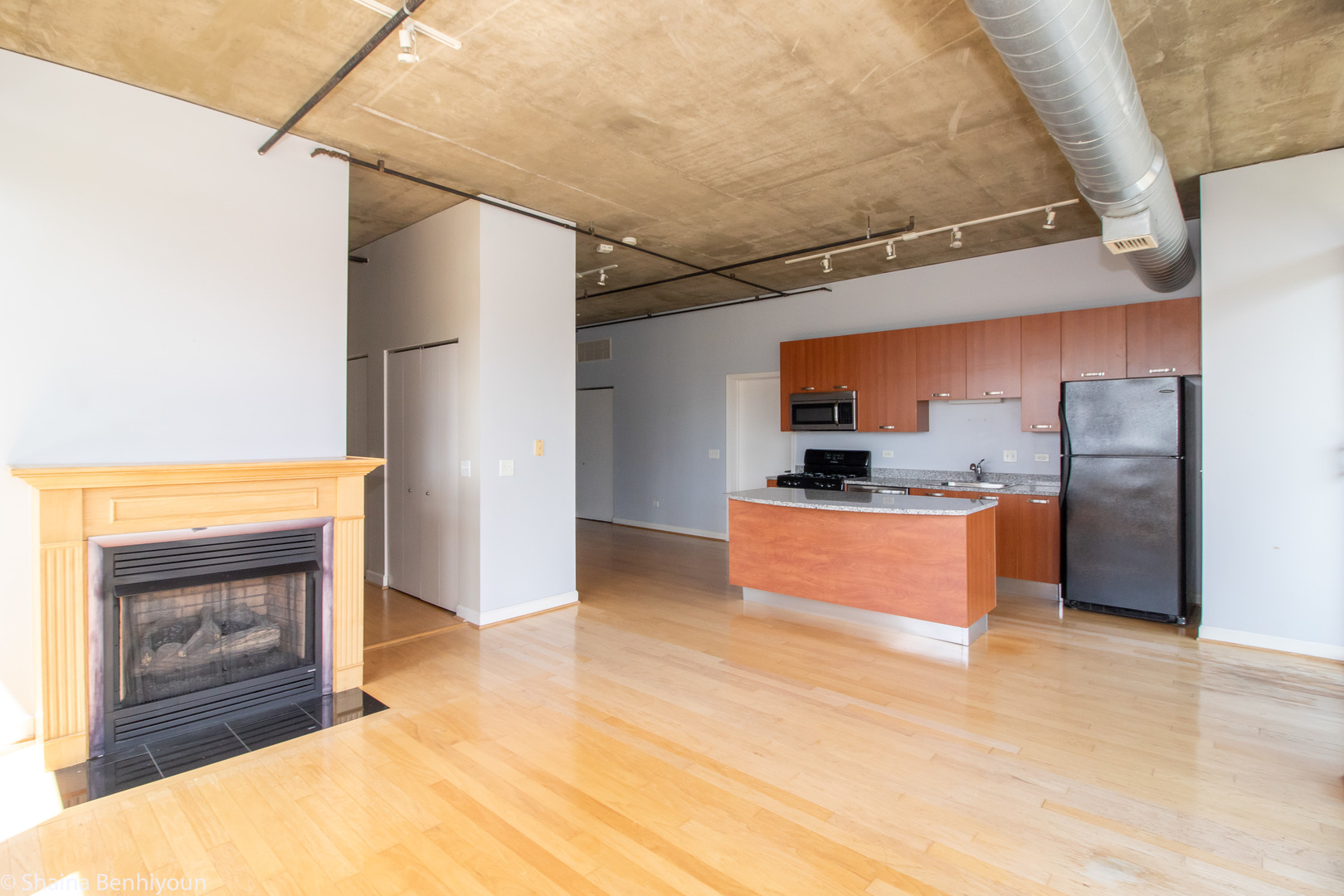 111 South Morgan Street, Unit 715 Chicago, IL 60607 - Photo 12 of 17 a kitchen with stainless steel appliances kitchen island granite countertop a refrigerator and a stove top oven