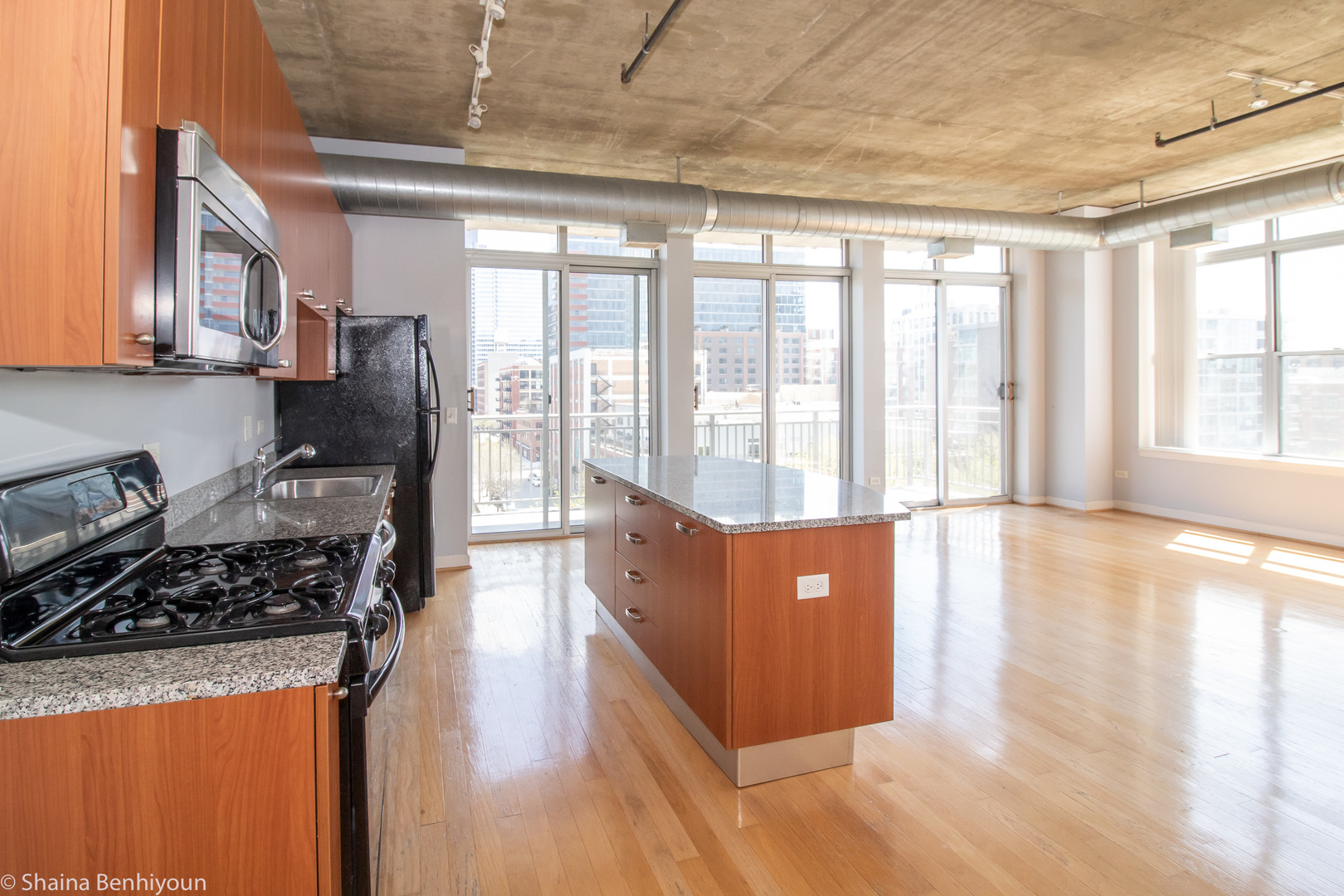 111 South Morgan Street, Unit 715 Chicago, IL 60607 - Photo 14 of 17 a kitchen with stainless steel appliances granite countertop a stove a refrigerator a sink and a dining table