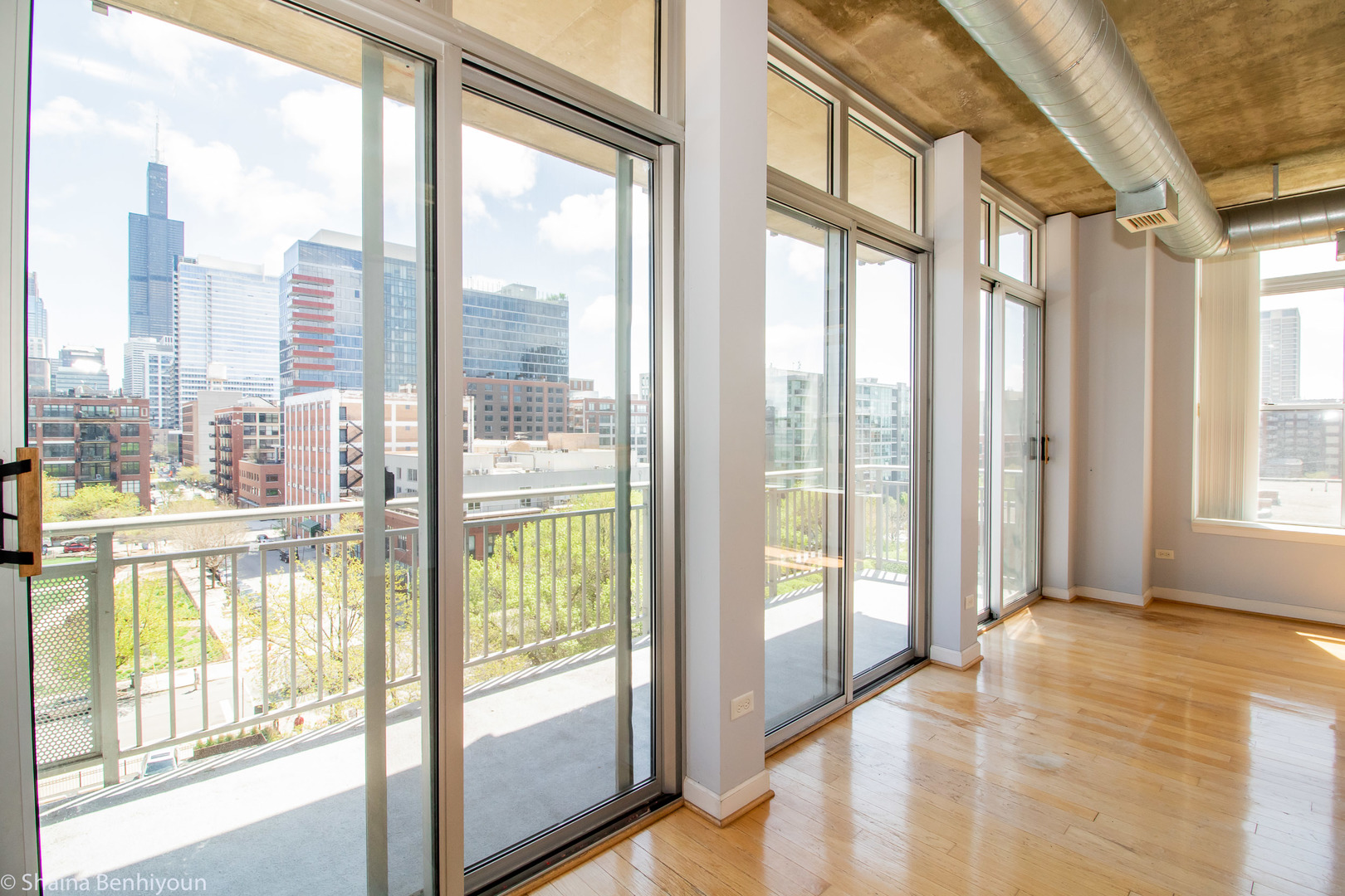 111 South Morgan Street, Unit 715 Chicago, IL 60607 - Photo 15 of 17 a view of an empty room with wooden floor and a window