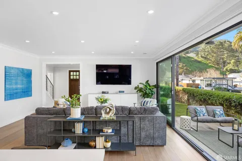 a living room with furniture and a potted plant