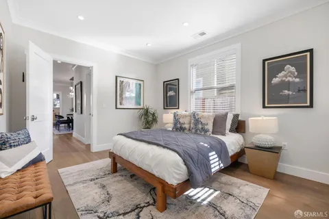 a kitchen with stainless steel appliances a dining table chairs and a potted plant