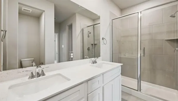 a bathroom with a sink double vanity and a mirror