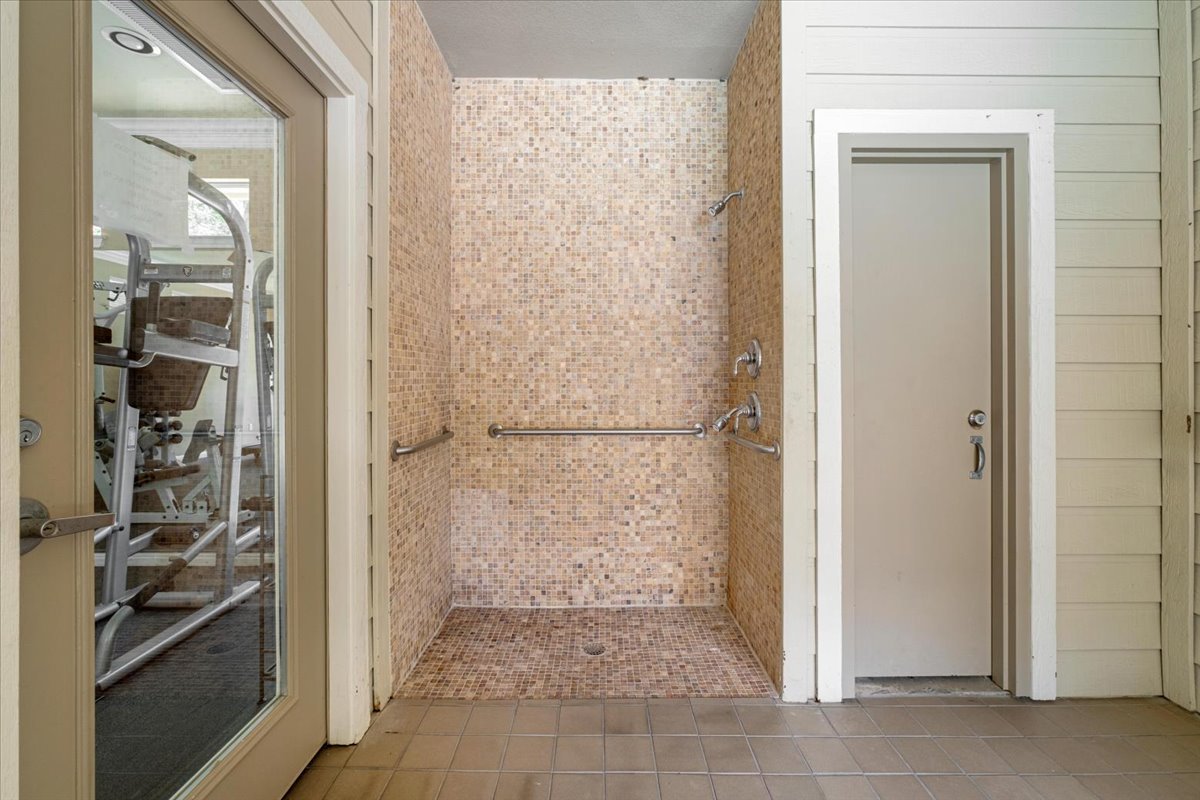 11000 Anderson Mill Road, Unit 11 Austin, TX 78750 - Photo 30 of 34 A convenient outdoor shower with mosaic tile is ready after a workout.