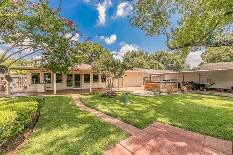 a view of a house with backyard patio and swimming pool