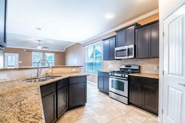 a bathroom with a granite countertop sink and a large mirror