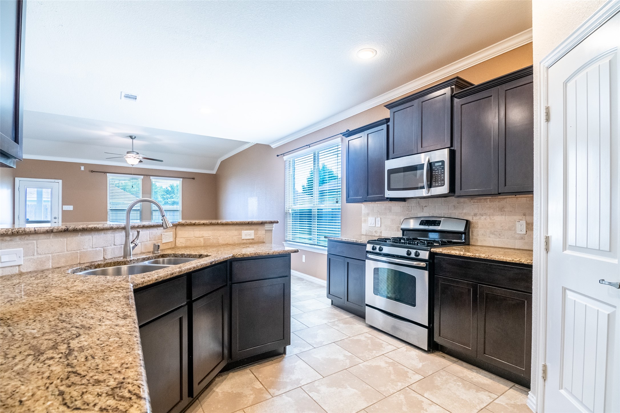 1610 Juniper Knoll Way Conroe, TX 77301 - Photo 14 of 41 a kitchen with stainless steel appliances granite countertop a sink stove and oven