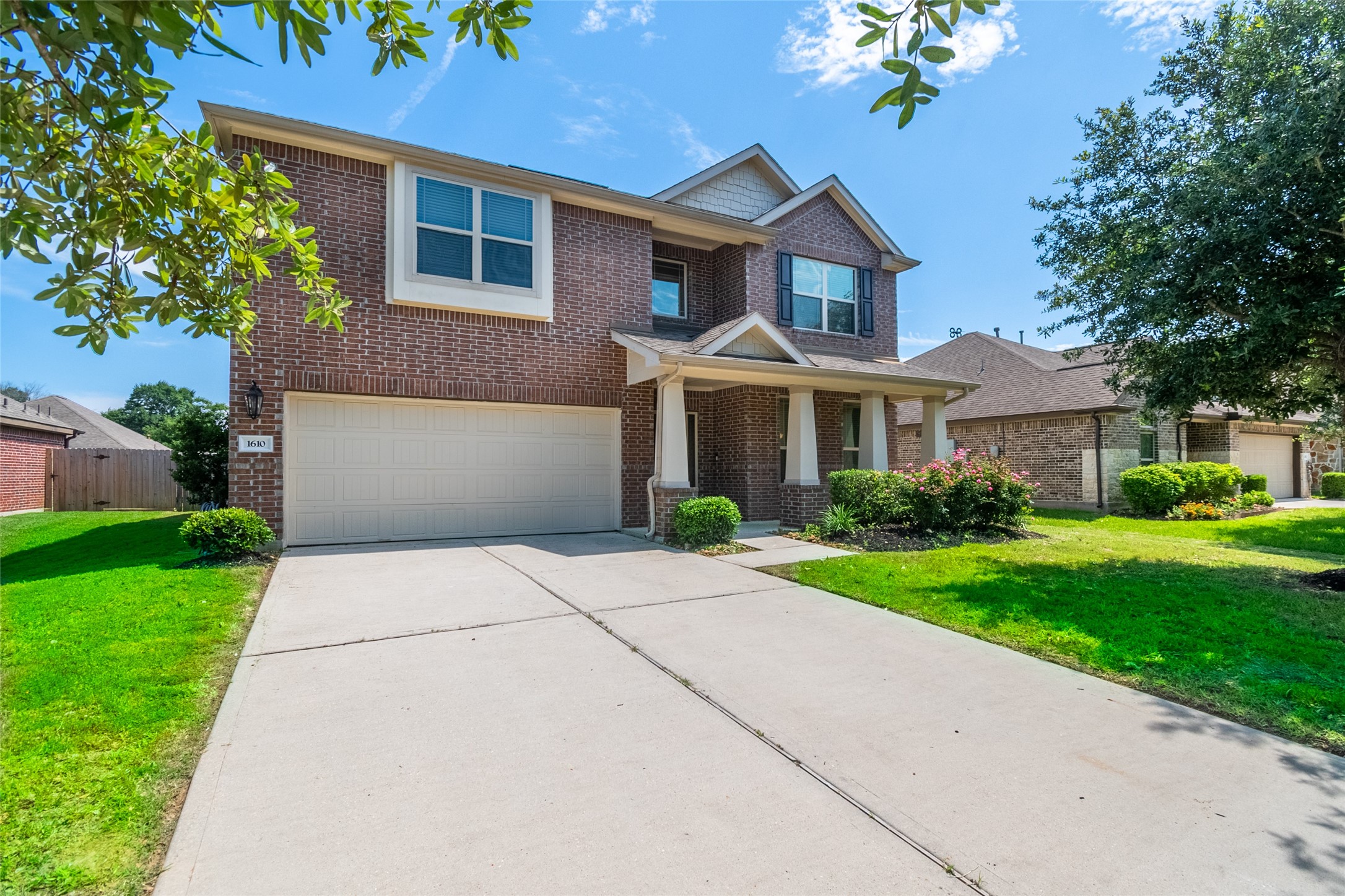 1610 Juniper Knoll Way Conroe, TX 77301 - Photo 3 of 41 a front view of a house with a yard and garage