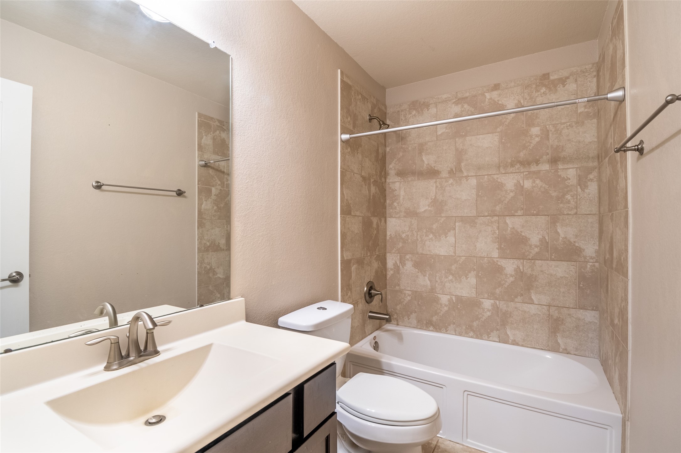 1610 Juniper Knoll Way Conroe, TX 77301 - Photo 36 of 41 a bathroom with a bathtub shower sink vanity mirror and toilet