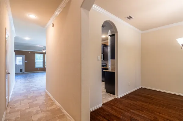 a view of a hallway with wooden floor and staircase