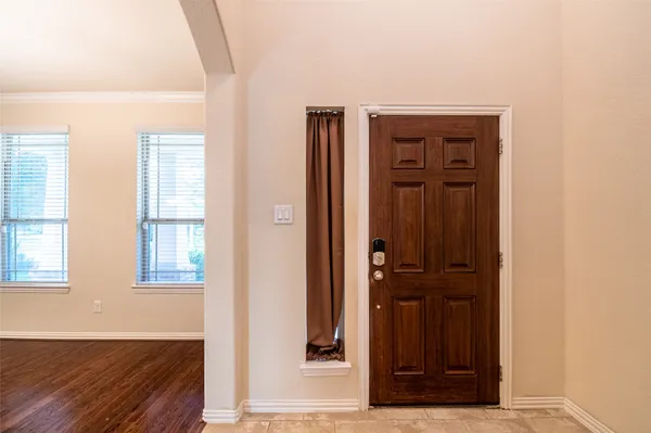 a view of a room with wooden floor and windows