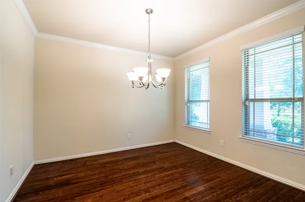 a view of a chandelier with wooden floor