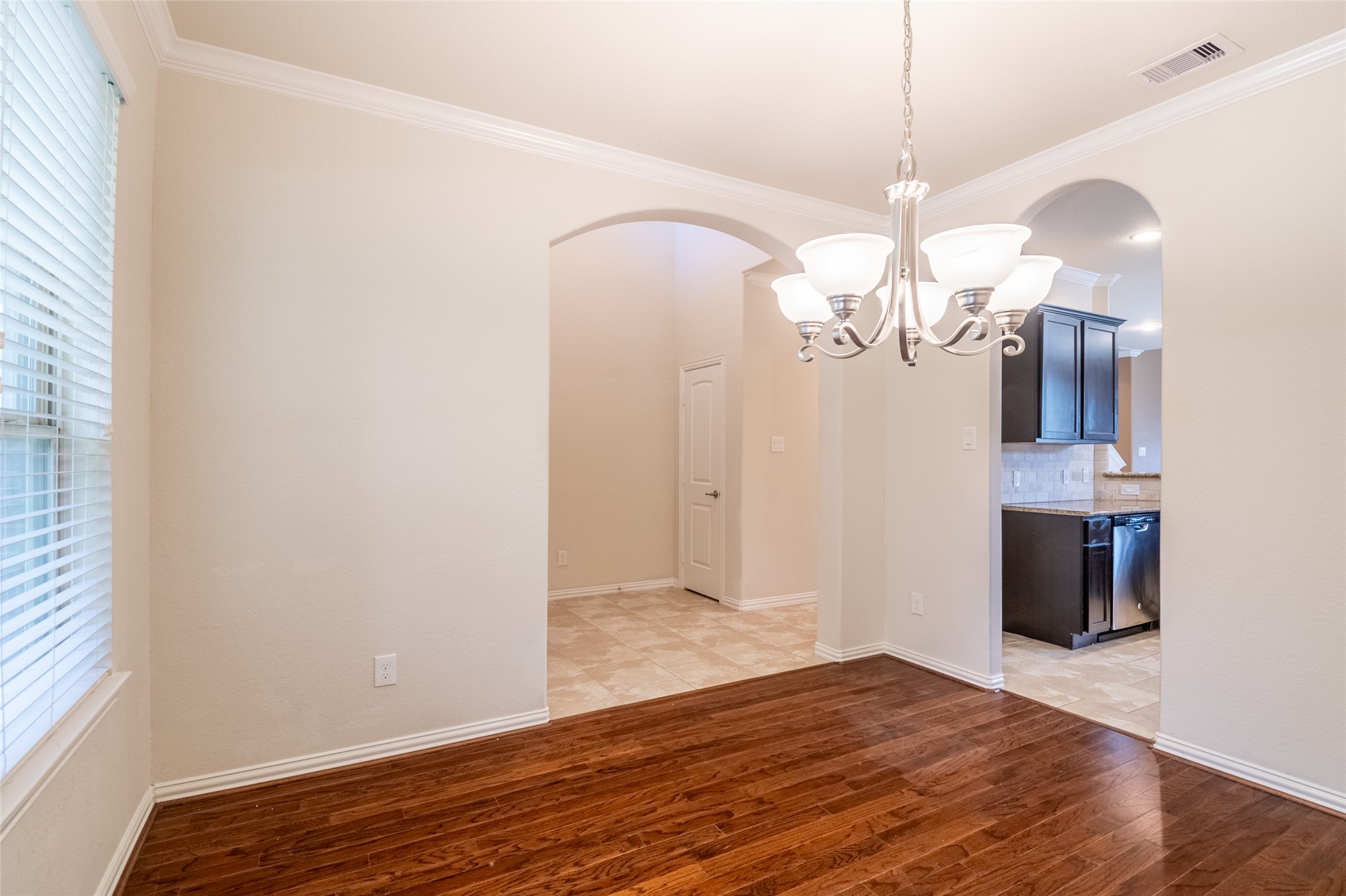 1610 Juniper Knoll Way Conroe, TX 77301 - Photo 8 of 41 a view of a chandelier with wooden floor
