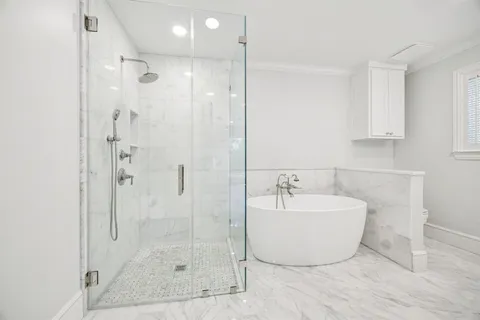 a bathroom with a bathtub and shower