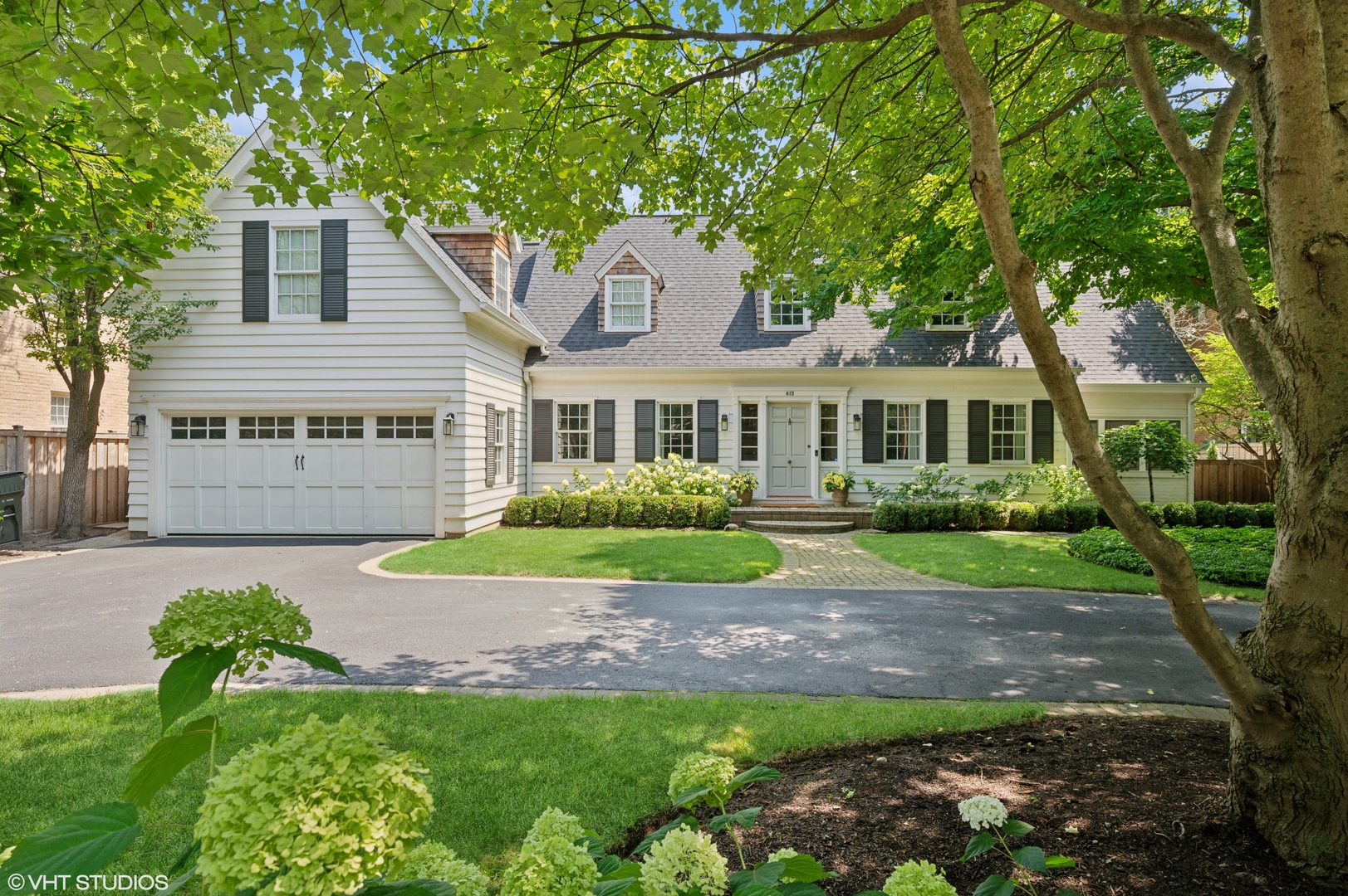 615 Ridge Road Kenilworth, IL 60043 - Photo 1 of 41 a front view of a house with a yard and garage