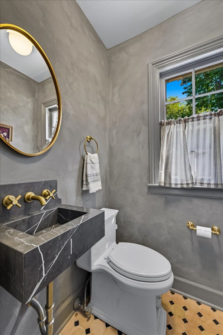 615 Ridge Road Kenilworth, IL 60043 - Photo 15 of 41 a bathroom with a toilet a sink and a mirror