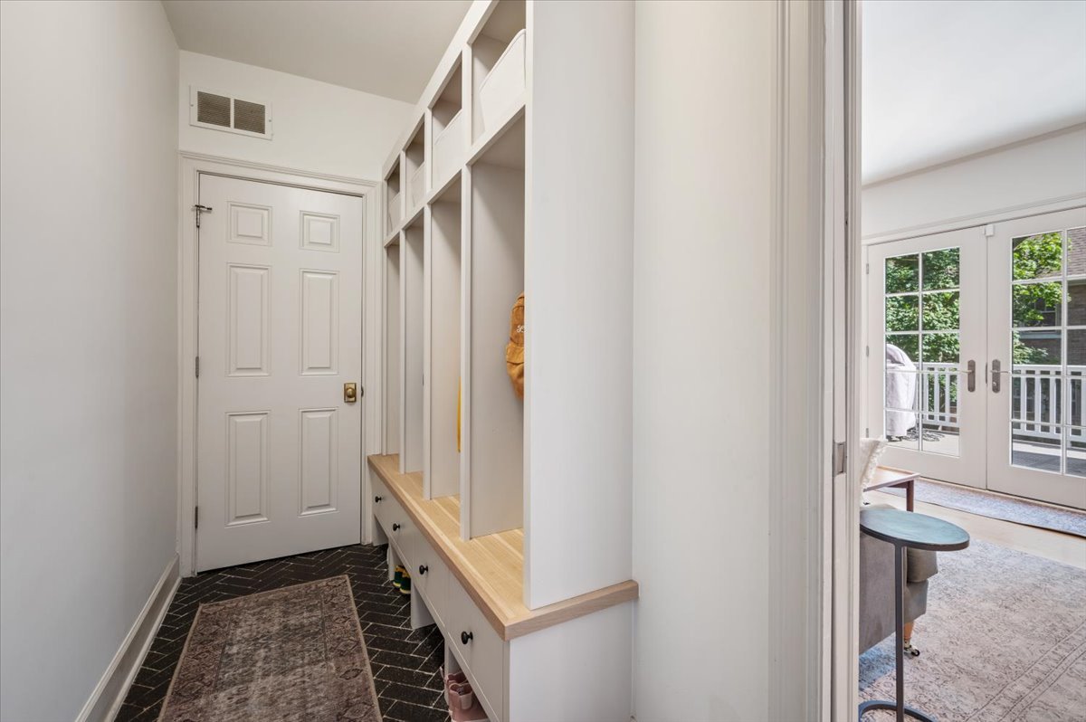 615 Ridge Road Kenilworth, IL 60043 - Photo 16 of 41 a view of a hallway with wooden floor and a bathroom