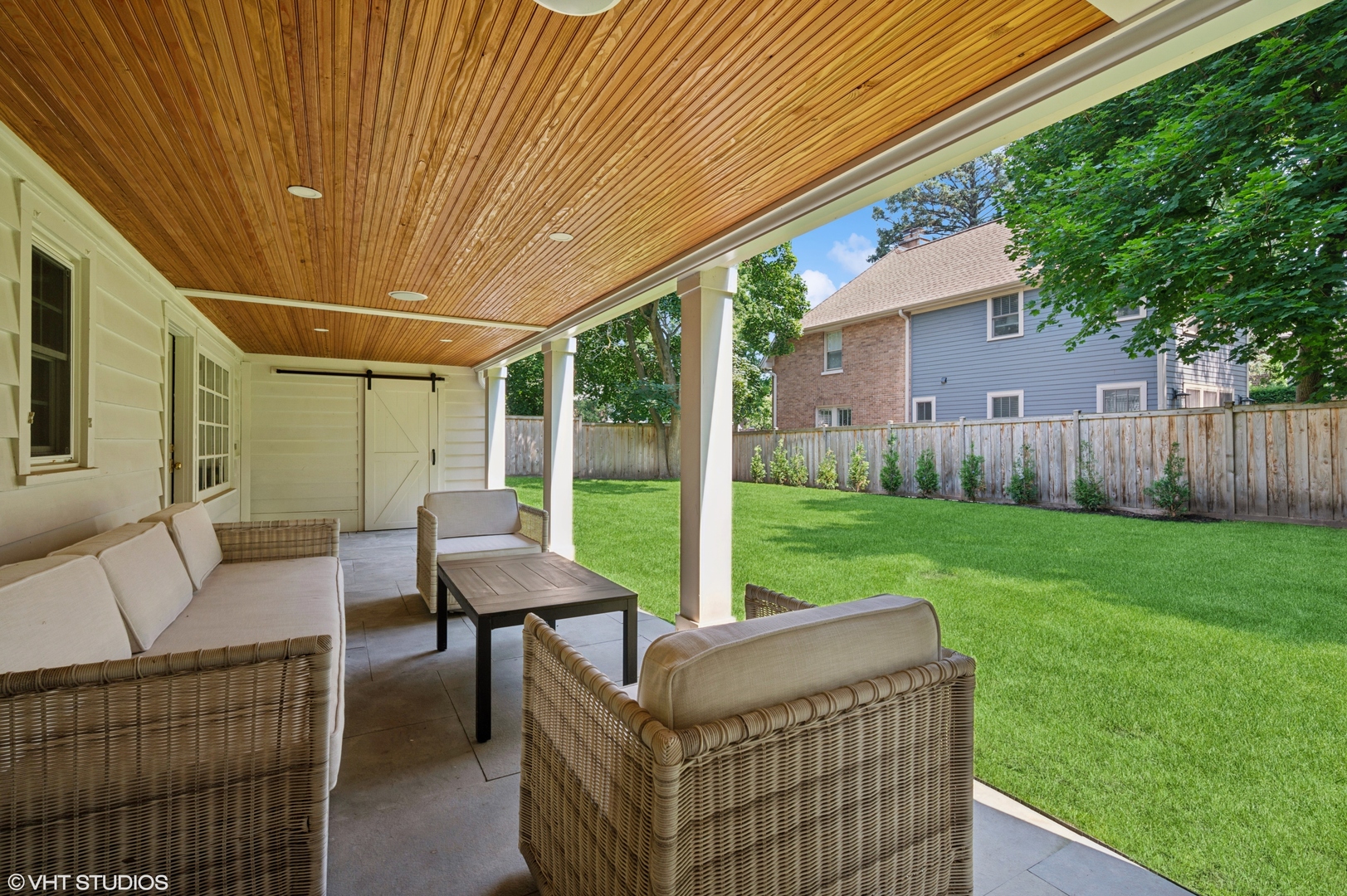 615 Ridge Road Kenilworth, IL 60043 - Photo 37 of 41 a view of a patio with couches and table and chairs with wooden fence and plants