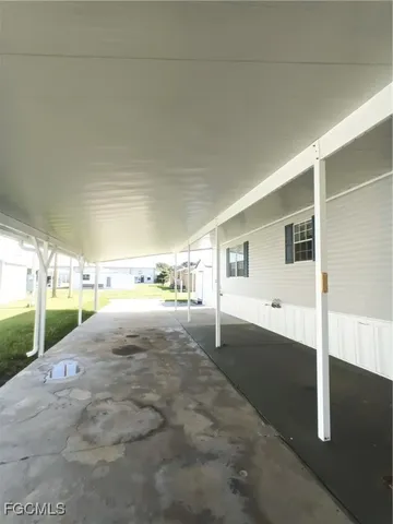 a view of a chair and table in backyard of the house