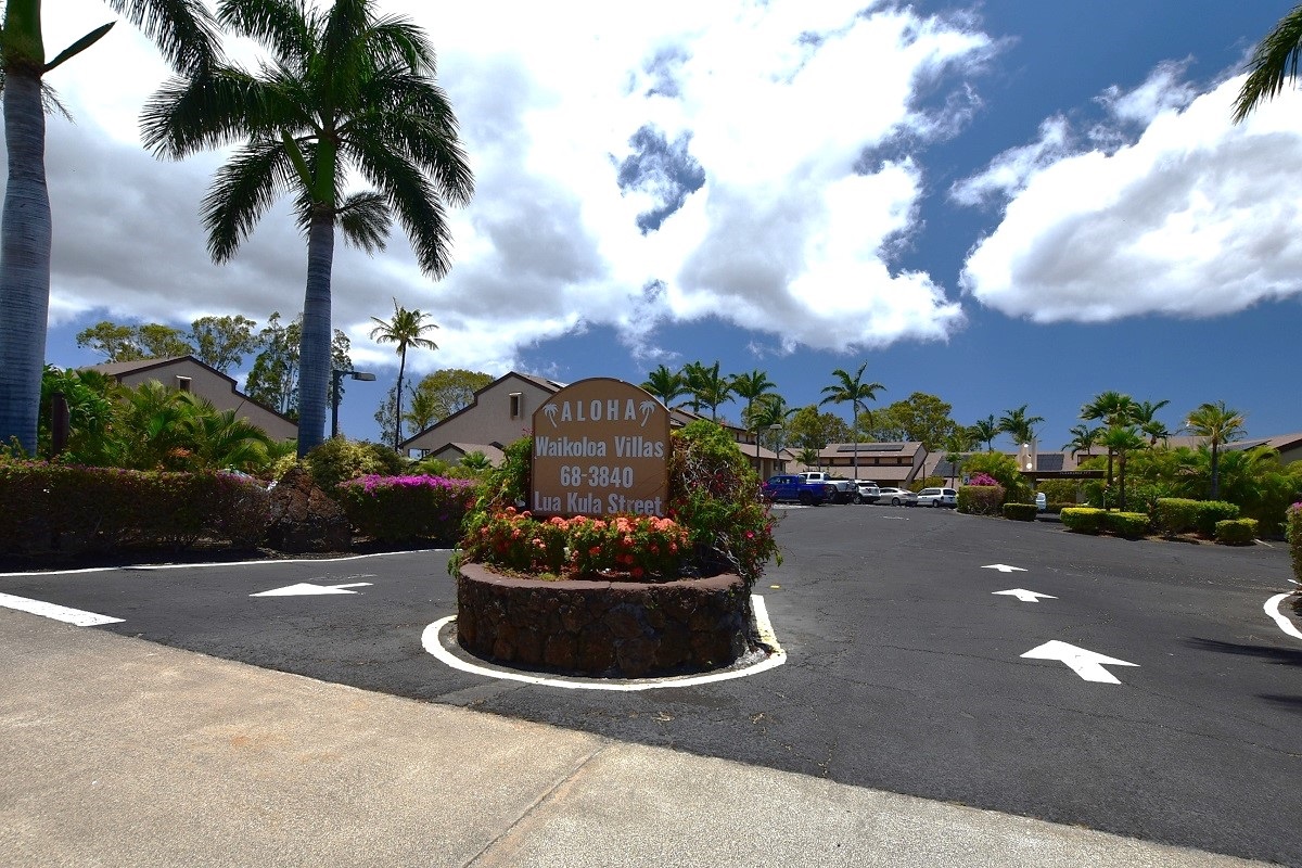 68-3840 Lua Kula Street, Unit D200 Waikoloa, HI 96738 - Photo 24 of 29 a swimming pool with a yard and palm trees
