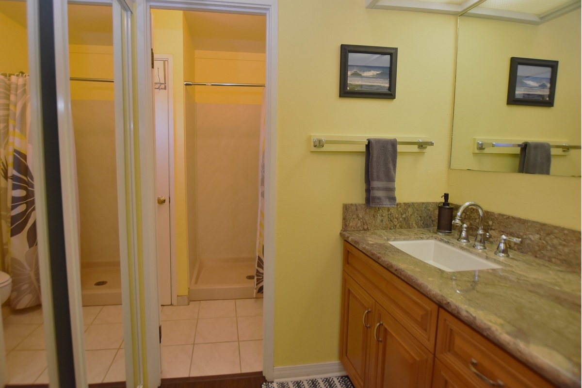 68-3840 Lua Kula Street, Unit D200 Waikoloa, HI 96738 - Photo 7 of 29 a bathroom with a granite countertop sink and a mirror