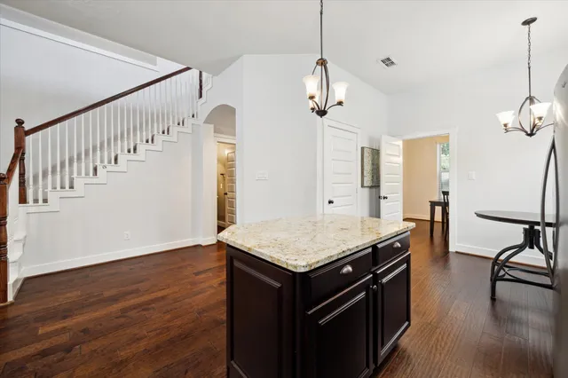 a kitchen with stainless steel appliances granite countertop a sink stove and microwave