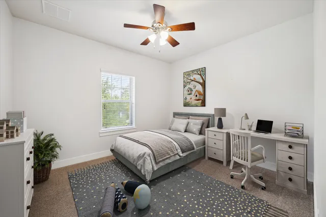 an empty room with windows and chandelier fan