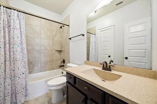 a bathroom with a sink toilet and mirror