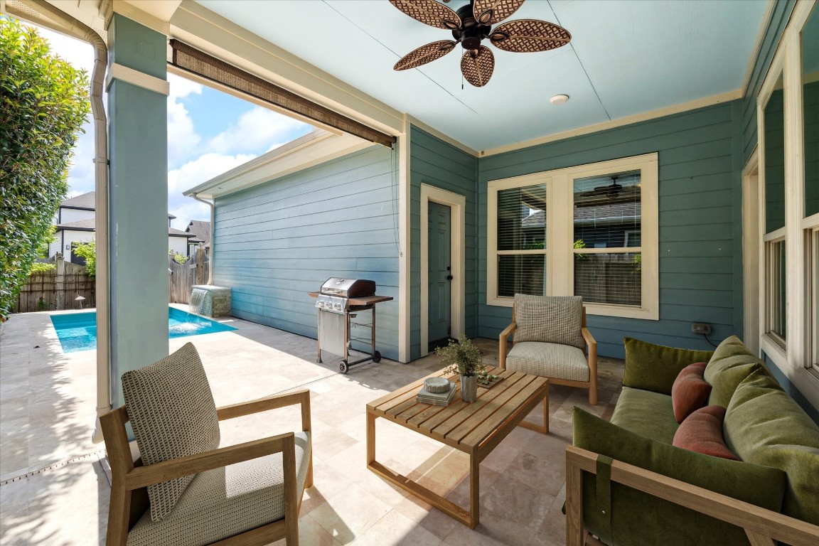 17011 Seminole Ridge Drive Cypress, TX 77433 - Photo 31 of 33 A charming covered patio allows for comfortable seating, with a shade and a ceiling fan, and a view of the pool. Ideal for outdoor relaxation and entertaining. *virtually staged