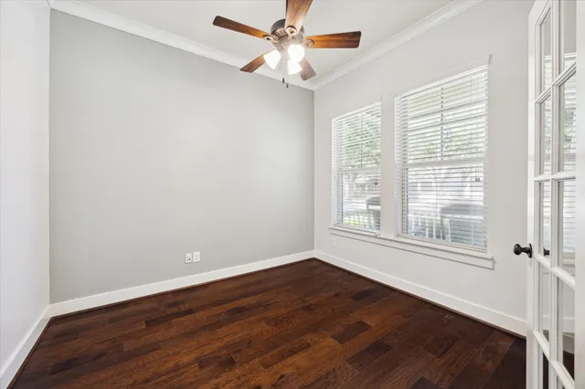 a dining room with furniture potted plants and wooden floor