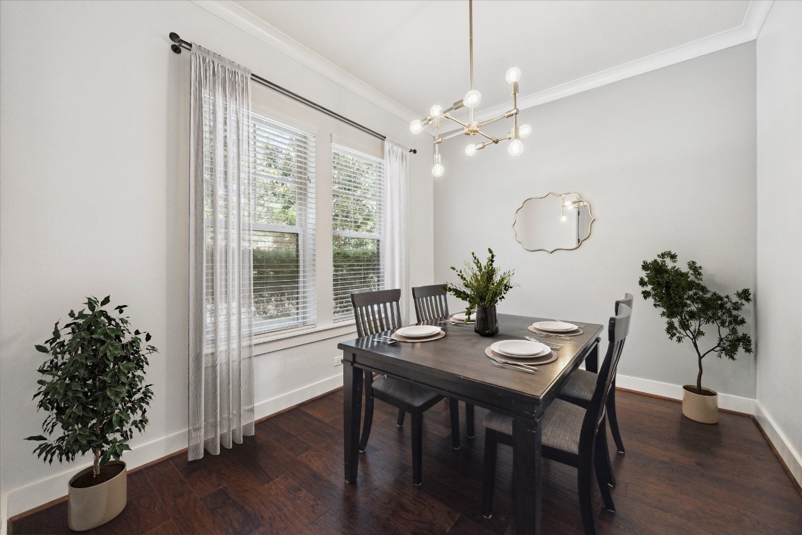 17011 Seminole Ridge Drive Cypress, TX 77433 - Photo 6 of 33 Bright dining room with large windows, modern updated chandelier, and hardwood floors.