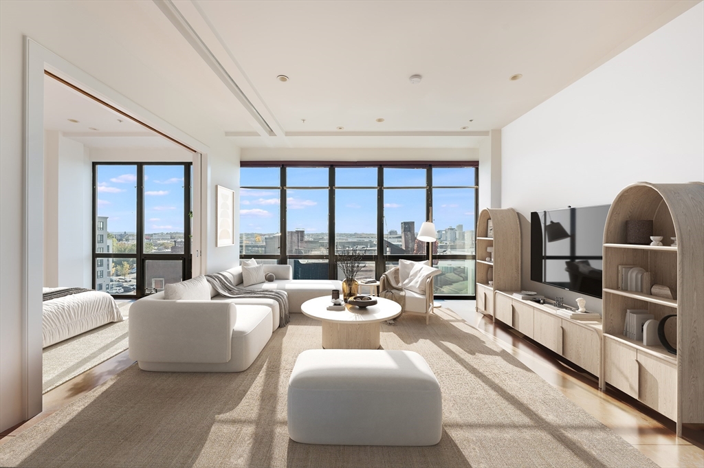 a living room with furniture and large windows