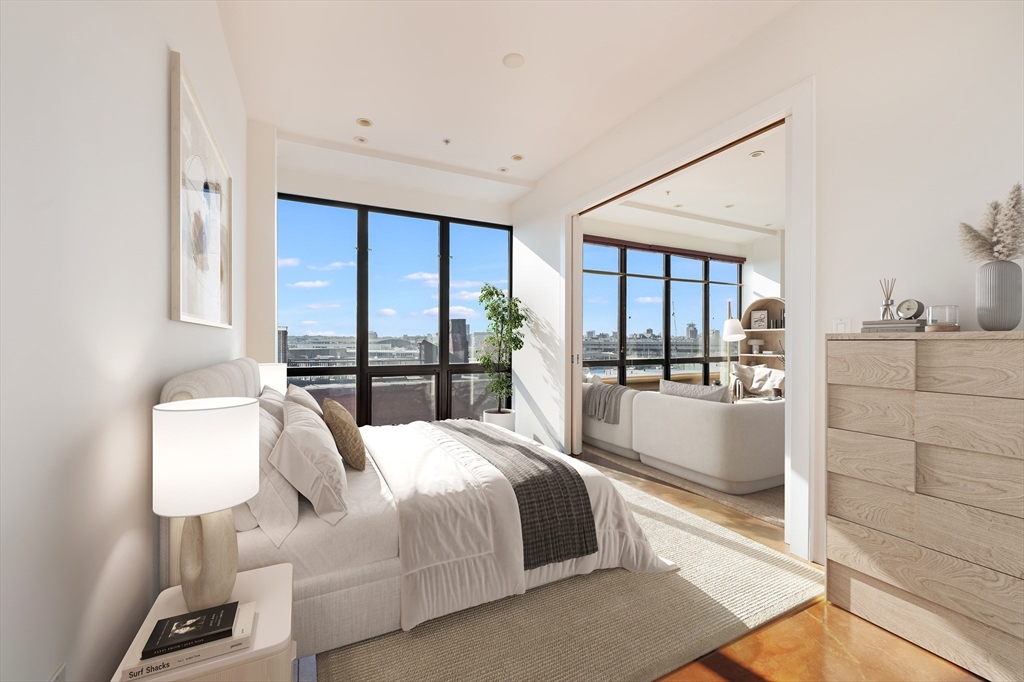 36 A Street, Unit 5D Boston, MA 02127 - Photo 5 of 13 a bedroom with a bed and large mirror