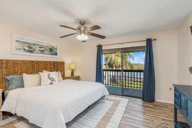 a bedroom with a balcony a bed and a window