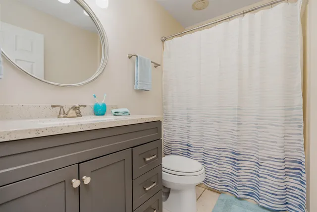 a bathroom with a toilet a sink and a mirror
