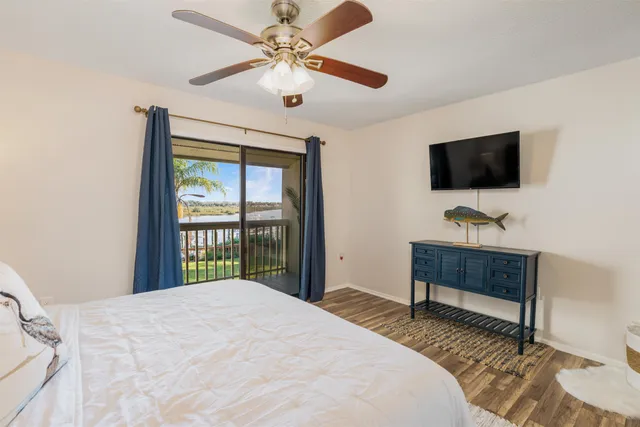 a bedroom with a bed window and a flat screen tv