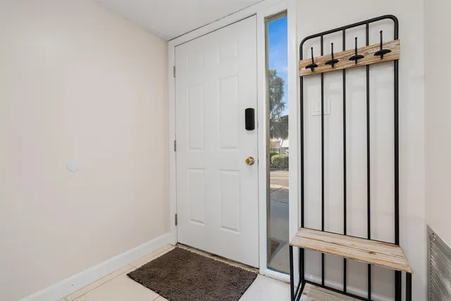 a view of a hallway with wooden floor and entryway