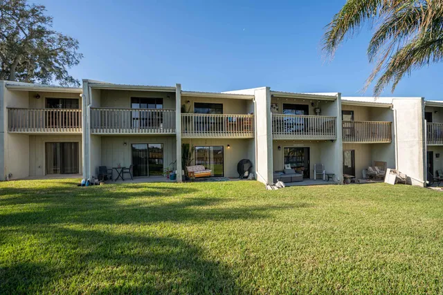 a view of a building with a yard